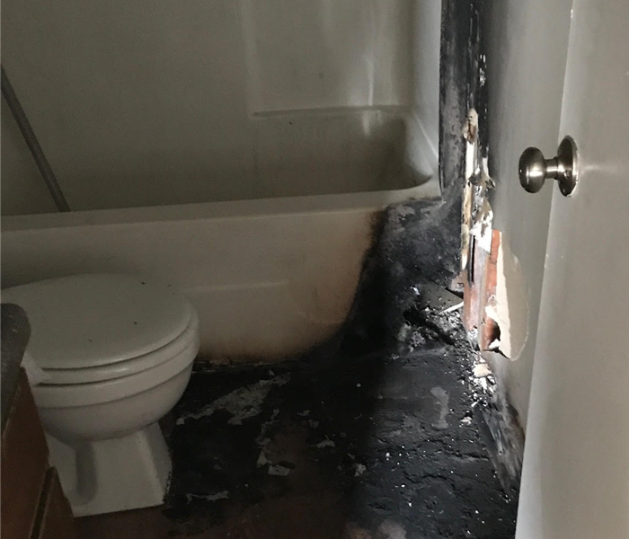 Ash and smoke damage in apartment bathroom