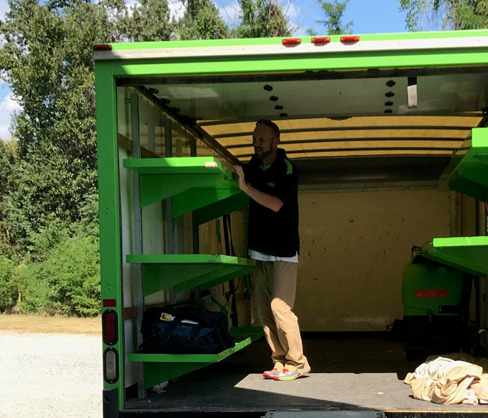 SERVPRO technician cleaning box truck after completing a job