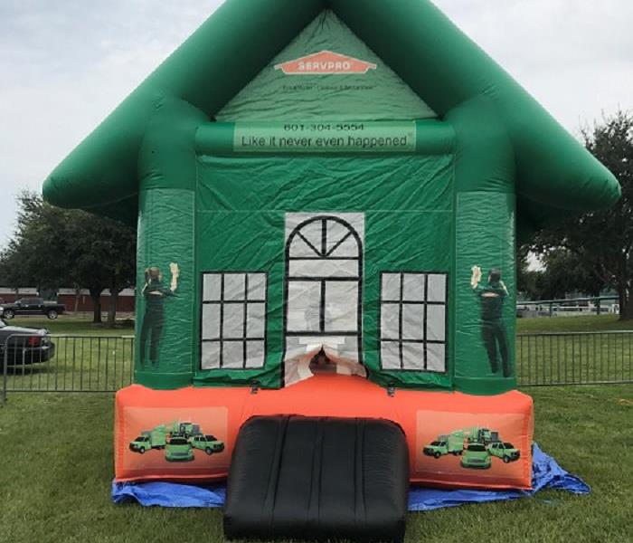 SERVPRO green and orange bounce house at community event